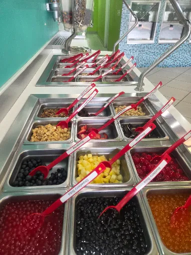 Topping bar with fresh fruit, boba, candy and nuts